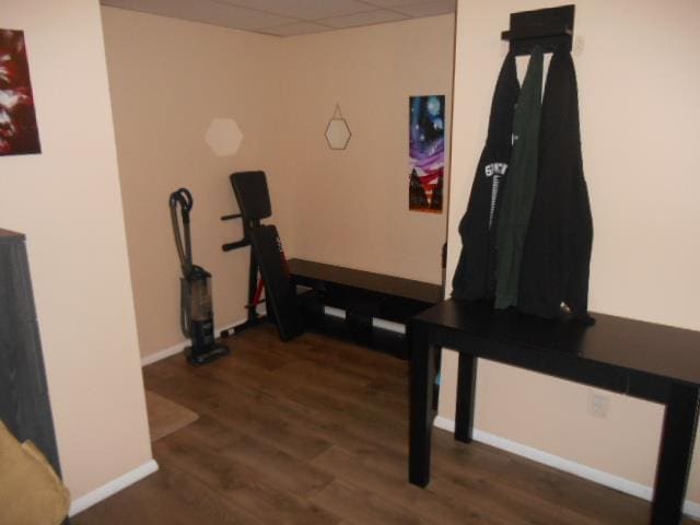 workout room with a drop ceiling and dark hardwood / wood-style floors