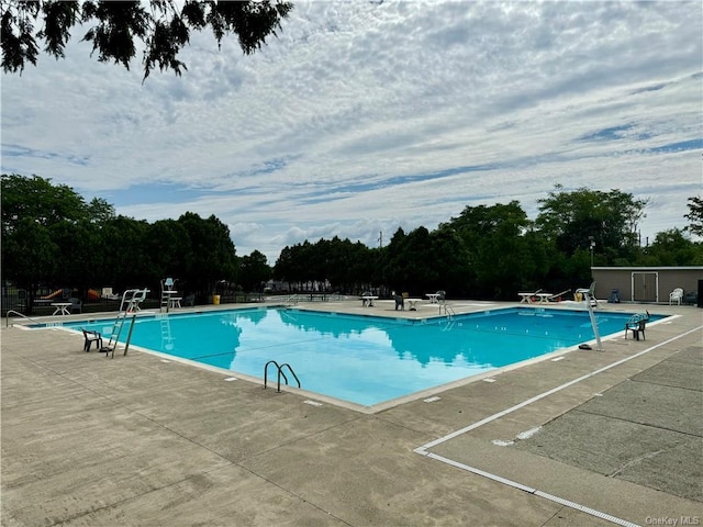 view of swimming pool with a patio area