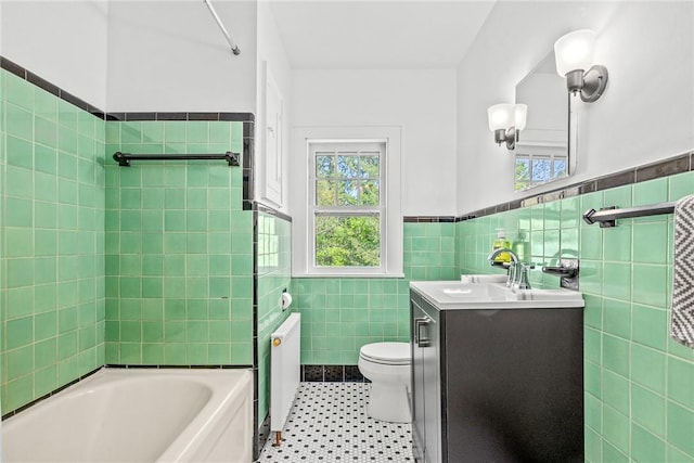 full bathroom featuring radiator, tile walls, vanity, toilet, and tile patterned floors