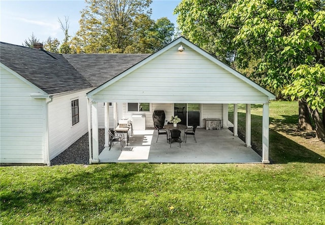 back of property featuring a patio and a lawn