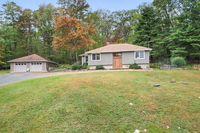 view of front of home featuring an outbuilding, a front lawn, and a garage