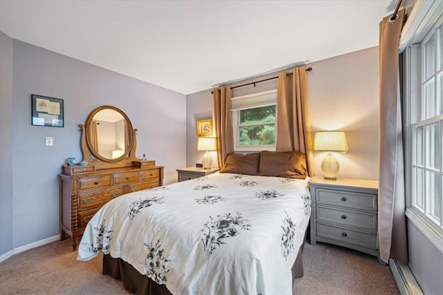 bedroom featuring baseboard heating and light carpet