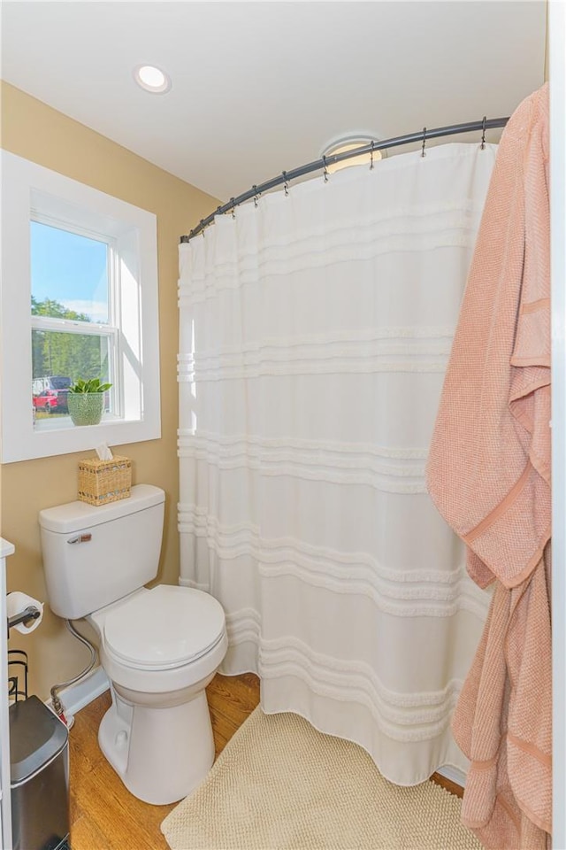 bathroom featuring hardwood / wood-style flooring and toilet