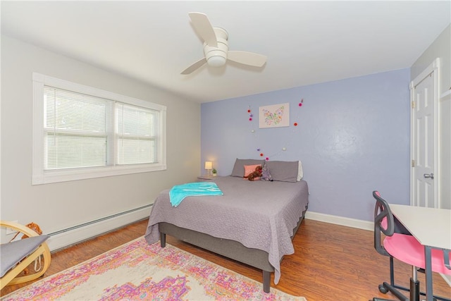 bedroom featuring hardwood / wood-style floors, a baseboard radiator, and ceiling fan