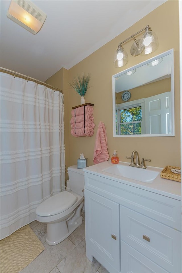 bathroom with tile patterned floors, vanity, and toilet