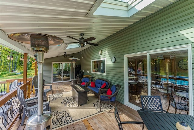 wooden terrace with outdoor lounge area and ceiling fan