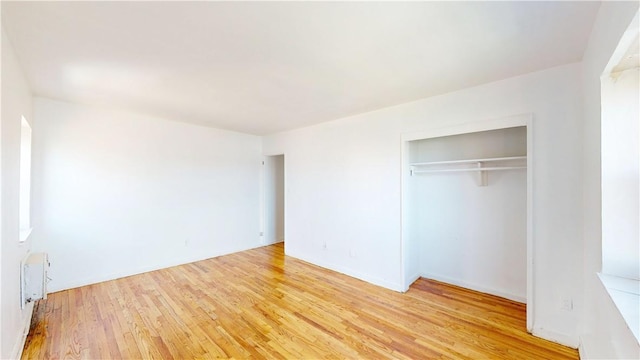 unfurnished bedroom featuring a closet and light hardwood / wood-style flooring