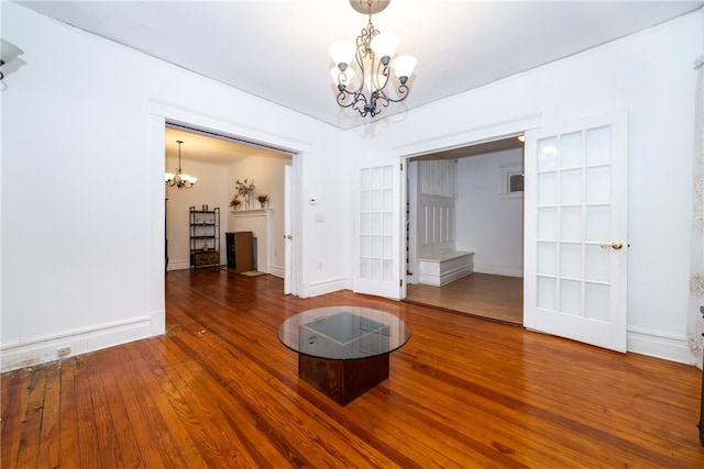 unfurnished dining area featuring hardwood / wood-style floors and a notable chandelier