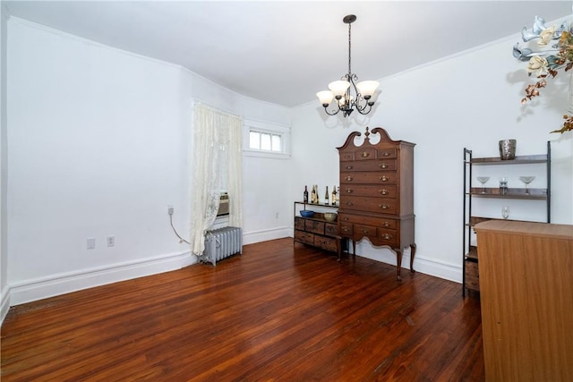 misc room with radiator, dark hardwood / wood-style flooring, a notable chandelier, and ornamental molding