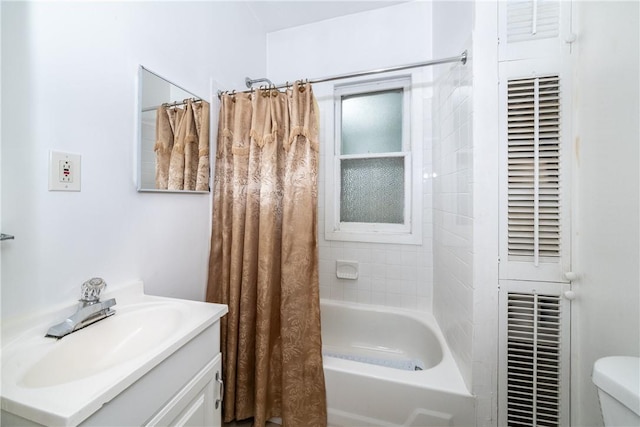 full bathroom with vanity, toilet, and shower / tub combo