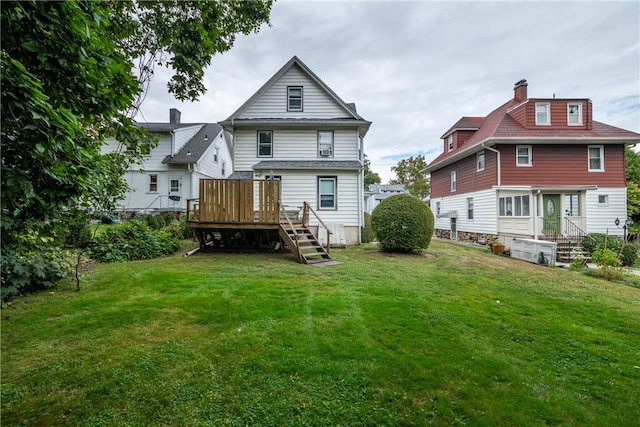 back of house featuring a yard and a deck