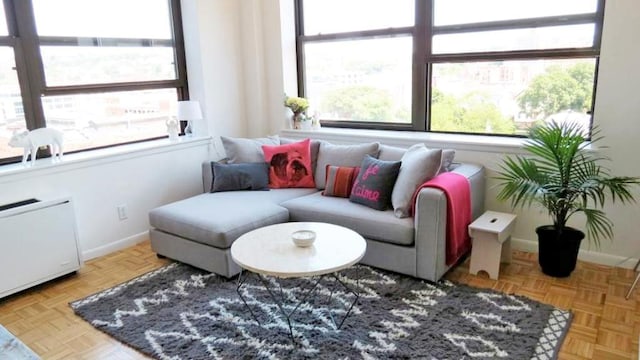 sunroom featuring radiator heating unit and plenty of natural light