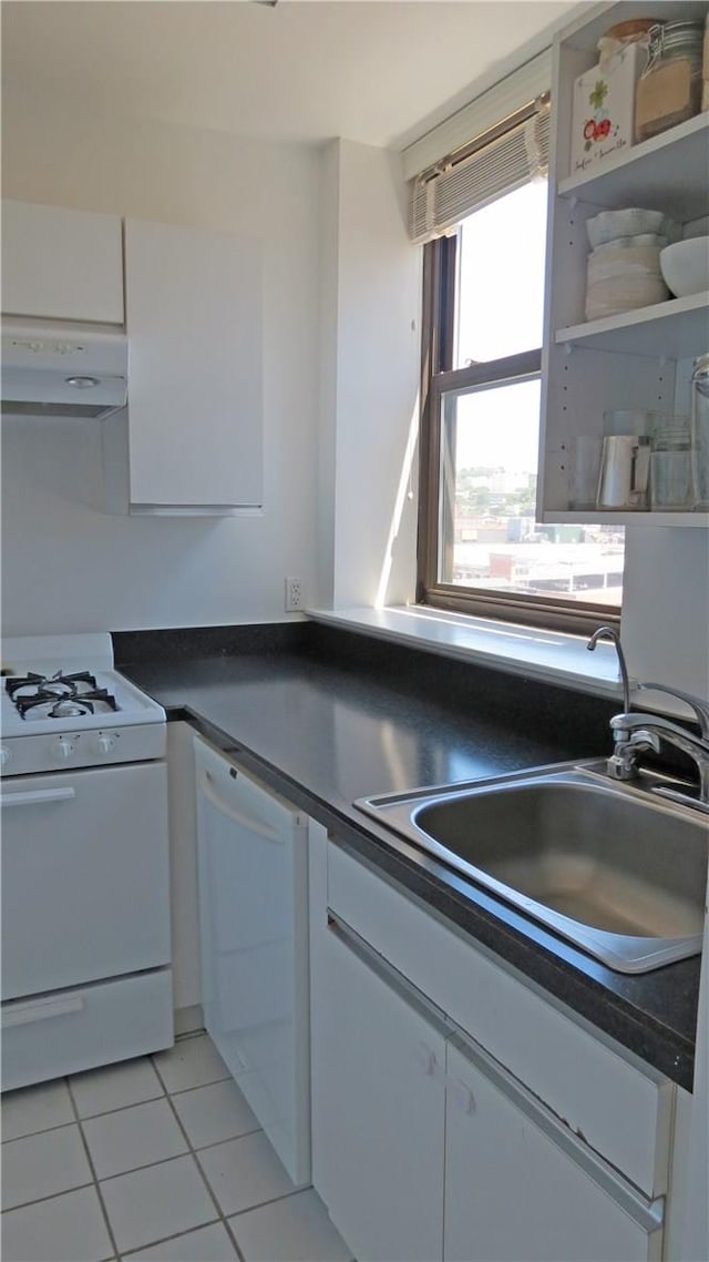 kitchen featuring white cabinets, light tile patterned flooring, white appliances, and sink