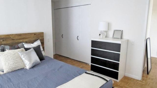 bedroom with light parquet flooring