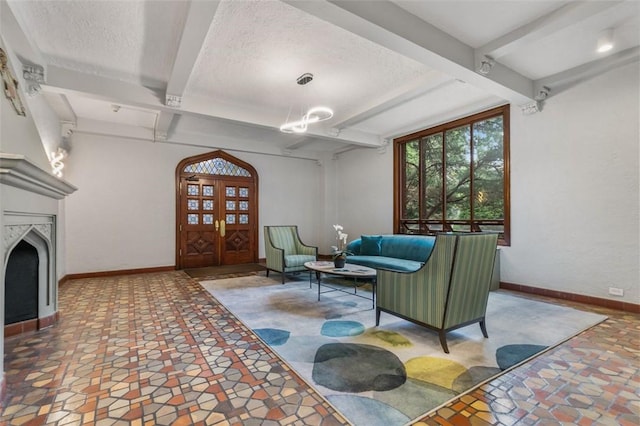 living room with beamed ceiling and a textured ceiling