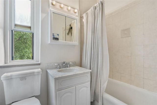 full bathroom with vanity, toilet, and shower / tub combo with curtain