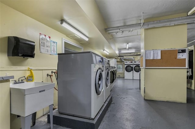 laundry room with washer and clothes dryer and sink