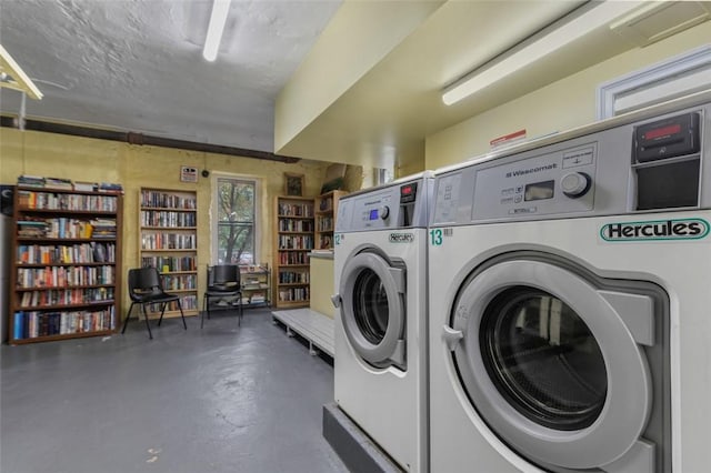 laundry room featuring a textured ceiling and washing machine and clothes dryer