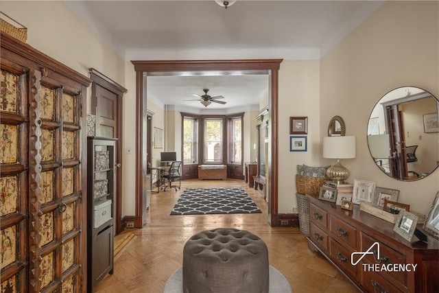 entrance foyer with ceiling fan and light parquet floors