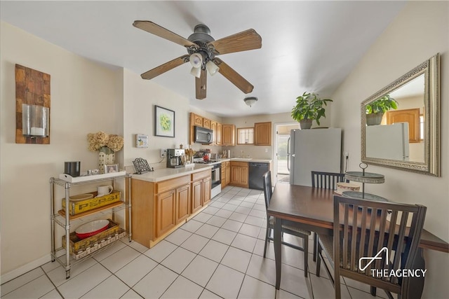 kitchen featuring ceiling fan, light tile patterned flooring, and white appliances