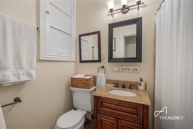 bathroom with vanity and toilet