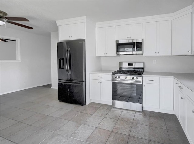 kitchen with white cabinets, ceiling fan, light tile patterned floors, and appliances with stainless steel finishes