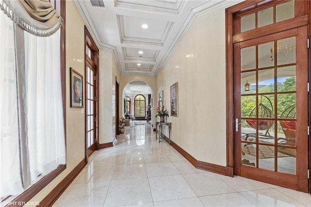 hall with coffered ceiling, ornamental molding, light tile patterned floors, and french doors