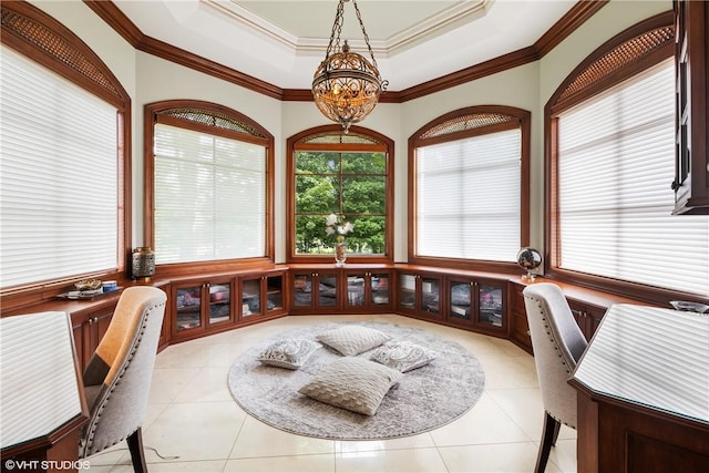 office space with light tile patterned floors, a tray ceiling, and ornamental molding