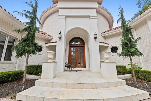 view of exterior entry featuring french doors