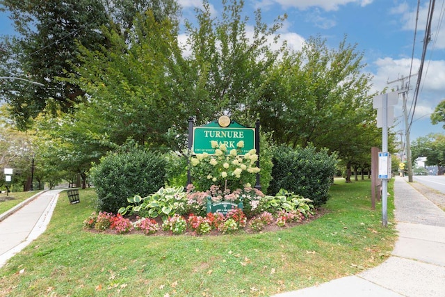 community / neighborhood sign with a lawn