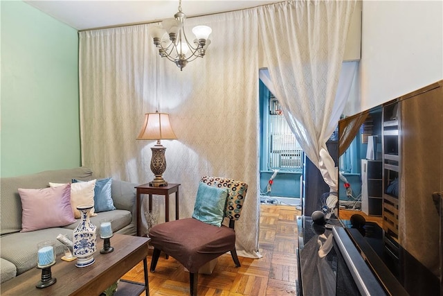 sitting room featuring a chandelier and parquet floors