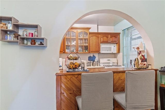 bar with white appliances and tasteful backsplash