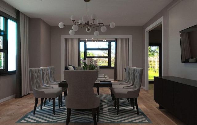 dining space featuring an inviting chandelier, a healthy amount of sunlight, and light wood-type flooring