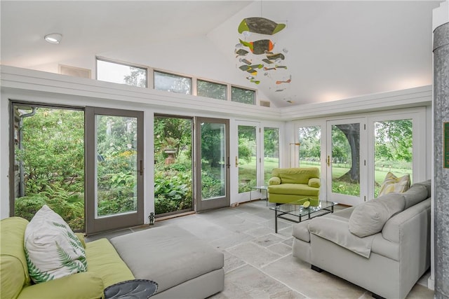 sunroom / solarium featuring french doors and vaulted ceiling