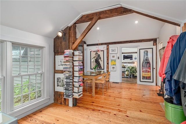 interior space featuring vaulted ceiling with beams and light hardwood / wood-style floors