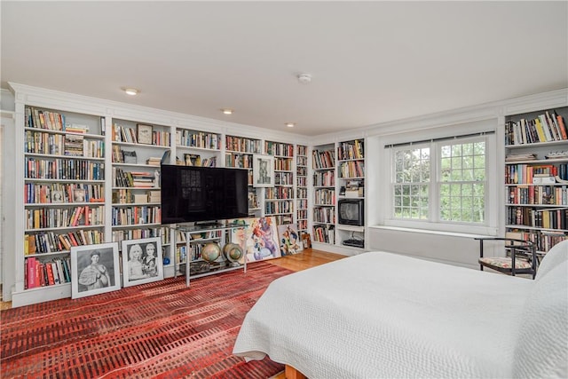 bedroom with crown molding and hardwood / wood-style floors