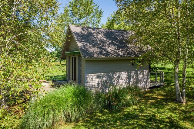 view of home's exterior featuring an outbuilding and a yard