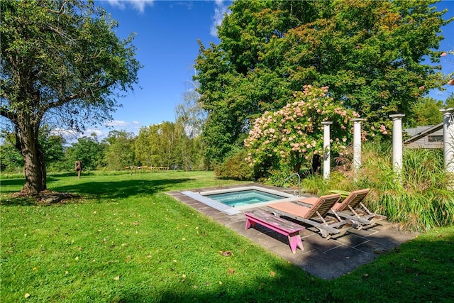 view of pool with a lawn and an in ground hot tub