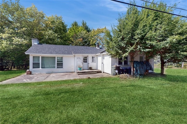 rear view of house featuring a patio area and a yard