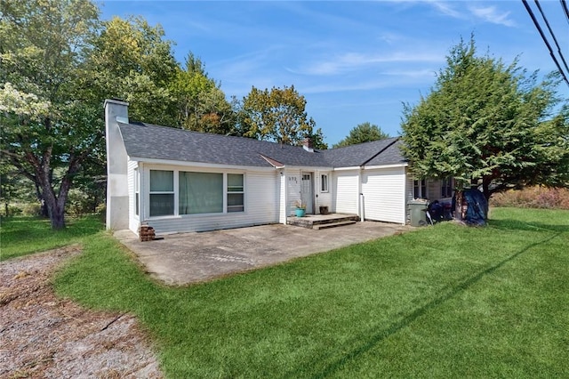 rear view of property featuring a patio area and a lawn