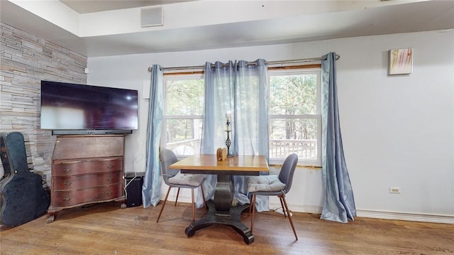 dining room featuring hardwood / wood-style flooring and a healthy amount of sunlight