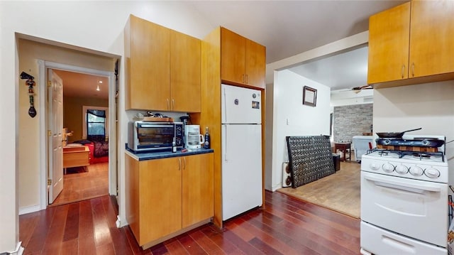 kitchen with dark hardwood / wood-style flooring and white appliances