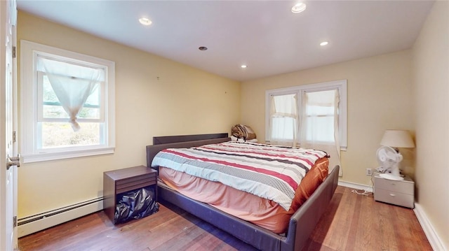 bedroom featuring hardwood / wood-style flooring and a baseboard radiator