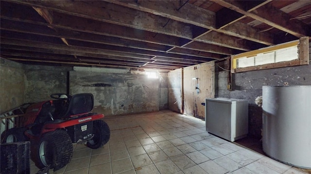 basement featuring fridge and water heater