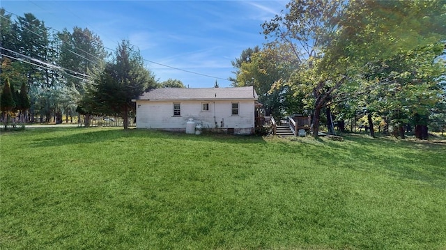 rear view of house featuring a yard