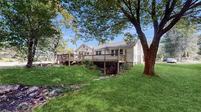 rear view of house featuring a wooden deck and a yard