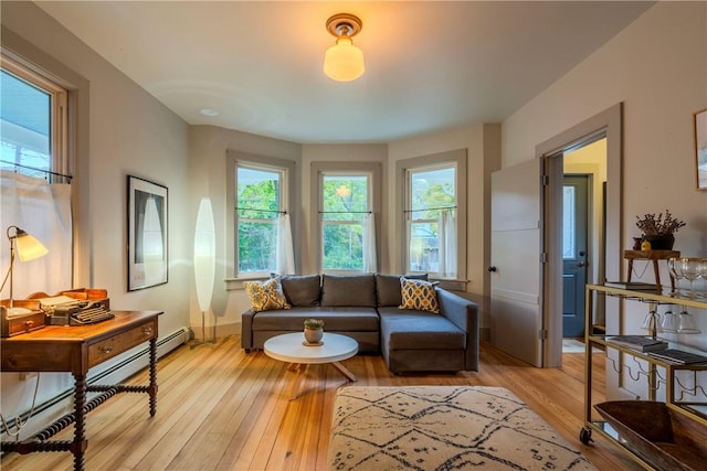 living room featuring baseboard heating and light hardwood / wood-style floors