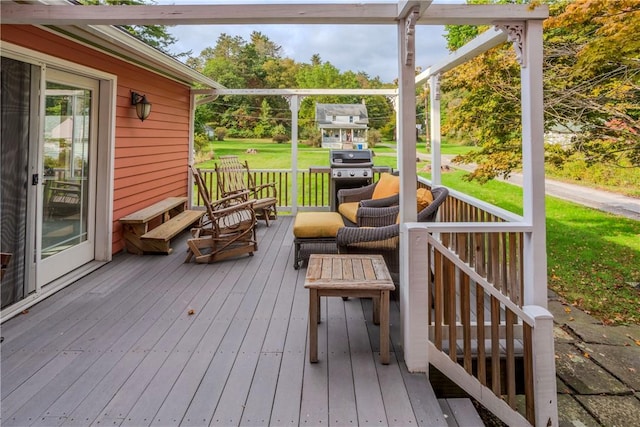 deck featuring grilling area and a lawn