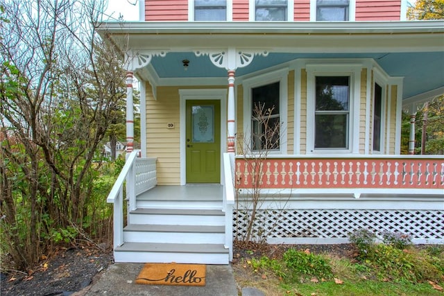 view of exterior entry with covered porch