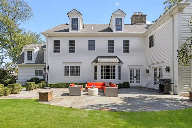 back of property featuring a patio area, a yard, outdoor lounge area, and french doors